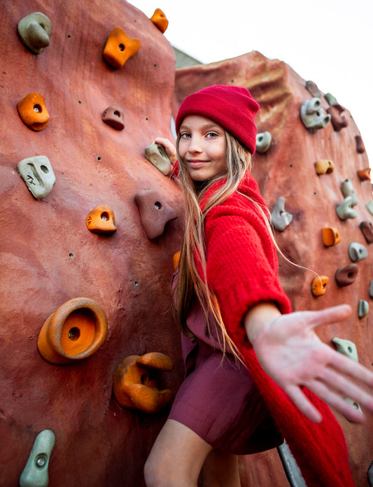 Girl on kids climbing wall