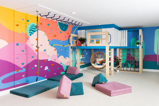 Vibrant kids playroom design with climbing wall and play mats
