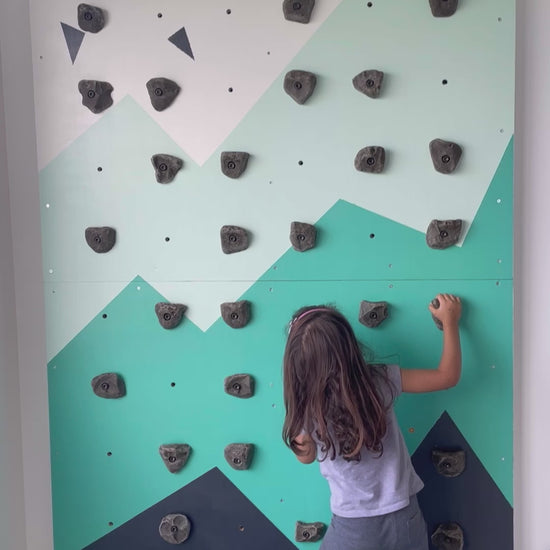 Little girl climbing Lil Boulder Kids Home climbing wall